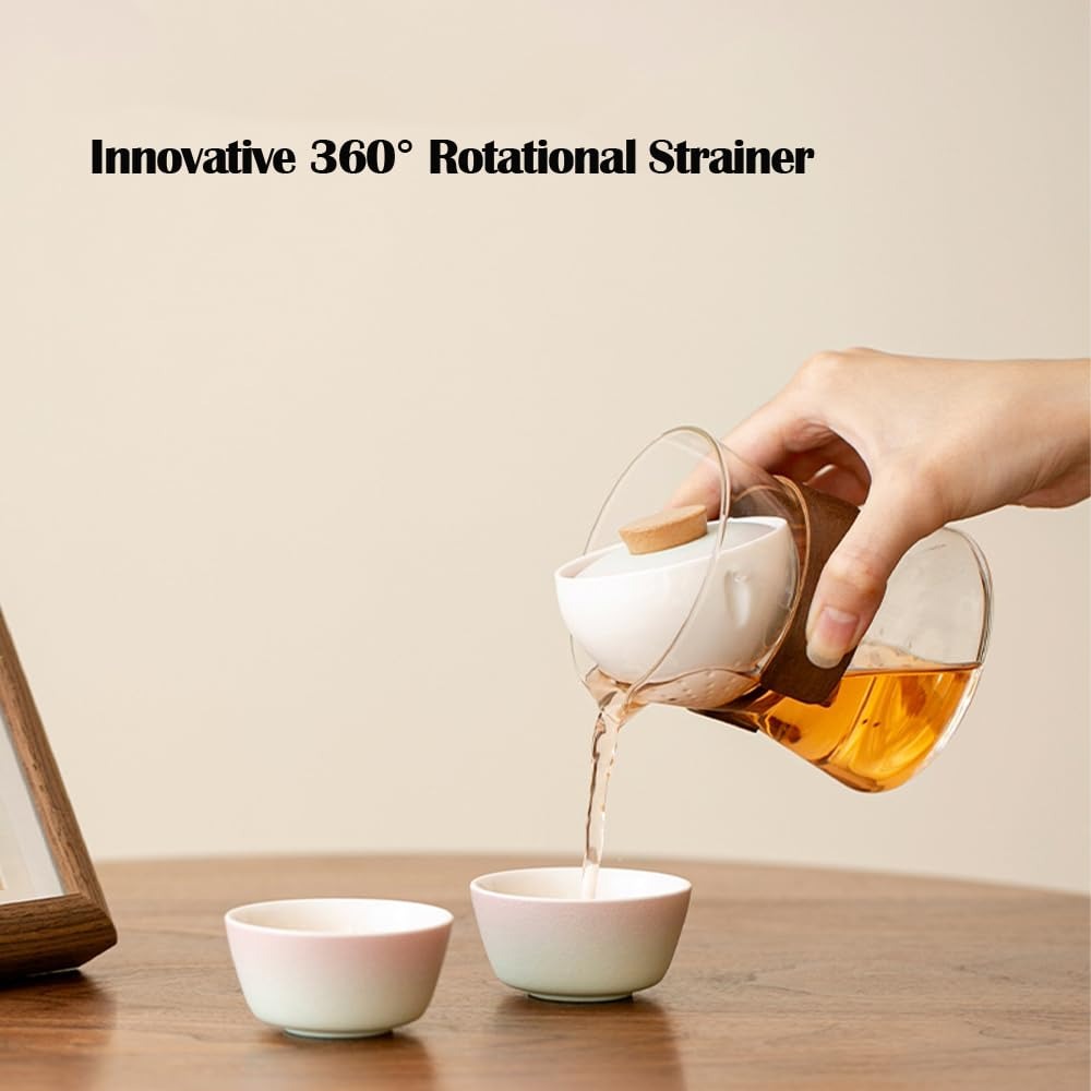 Hand effortlessly pouring golden tea using an innovative glass teapot with a 360-degree rotational ceramic strainer.