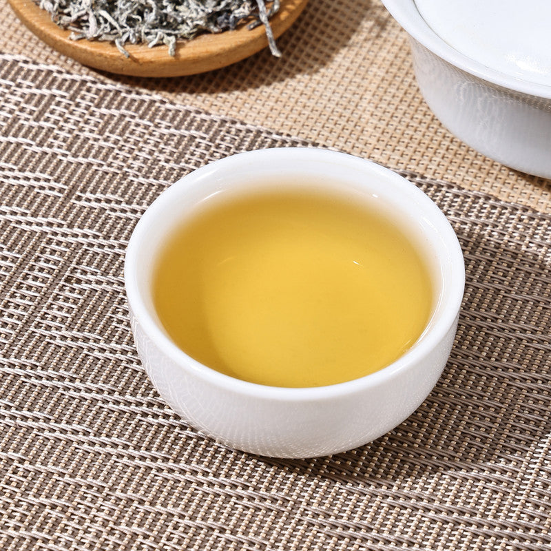 A close-up view of the bright, golden liquor of a prepared cup of Teng Cha, highlighting a relaxing and caffeine-free healthy experience.