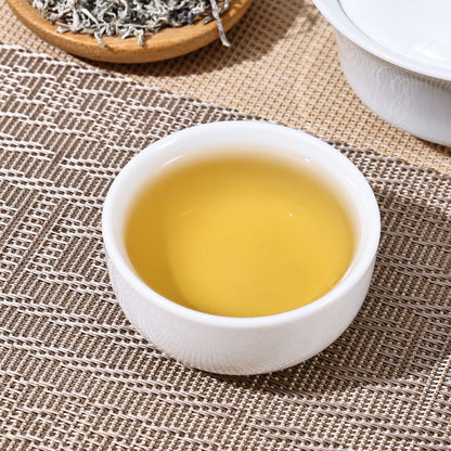 A close-up view of the bright, golden liquor of a prepared cup of Teng Cha, highlighting a relaxing and caffeine-free healthy experience.