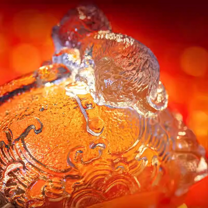 A premium handcrafted glass teacup combining a playful cat figurine with intricate traditional relief patterns and a sparkling hammered ice-crackle texture, isolated on a white background.