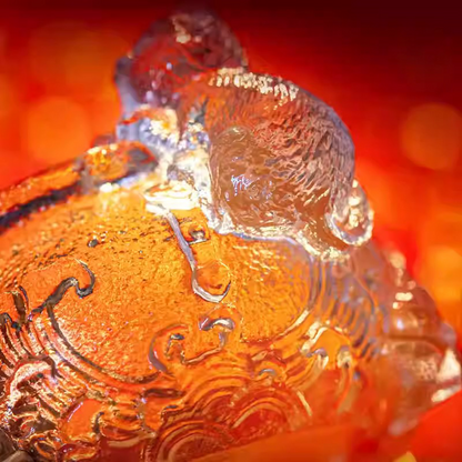 A premium handcrafted glass teacup combining a playful cat figurine with intricate traditional relief patterns and a sparkling hammered ice-crackle texture, isolated on a white background.