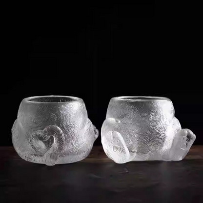 A pair of handcrafted glass teacups showing the full design: one with a heart-shaped curled tail and the other with adorable cat paws, both featuring a sparkling fur texture.