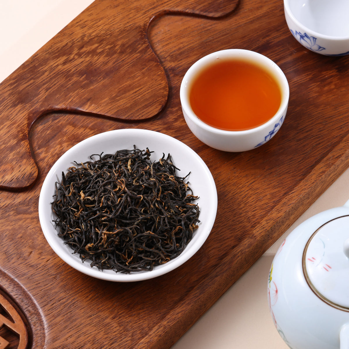 Premium tea from the core growing region with slender dried leaves and clear pale yellow tea liquor.