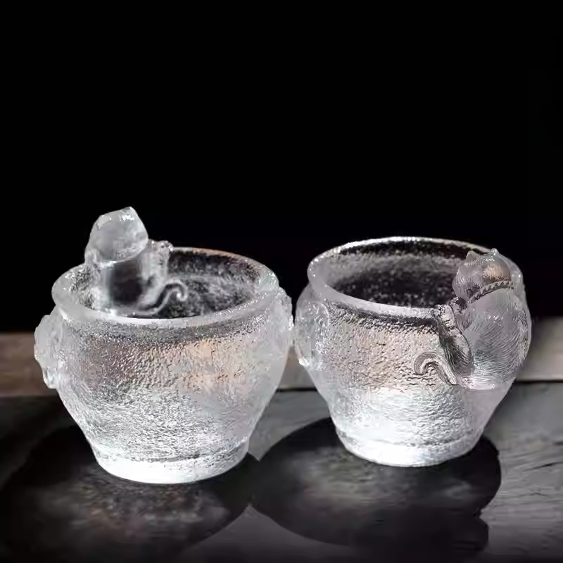 A charming pair of handcrafted cat-themed glass teacups with sparkling ice-crackle texture, perfectly presented as a unique gift set for cat lovers.