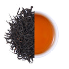 Premium Gaoshan Selenium Rich Black Tea from Hubei, China, featuring twisted loose leaf tea and a bright amber-red tea infusion with a rich aroma