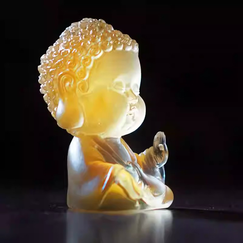 Exquisite handcrafted monk figurine used as a tea pet, glowing beautifully under soft light to symbolize mindfulness and good fortune.