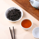High mountain selenium black tea with dark loose leaves and rich reddish amber tea liquor.
