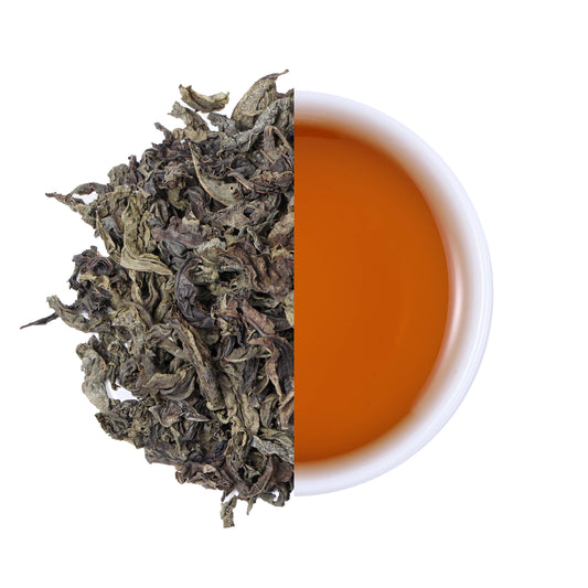 Premium Laifeng Vine Tea large leaves and amber tea infusion comparison, showcasing the natural leaf texture and rich flavor of caffeine-free herbal tea from Hubei, China