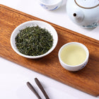 Premium Enshi Yulu steamed green tea with needle-shaped leaves and clear pale green tea liquor.
