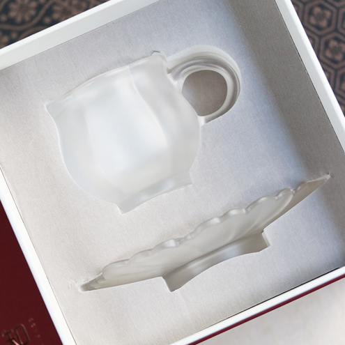 Detail of professional teaware packaging showing custom-molded protective inserts that ensure the frosted glass set arrives in perfect condition.