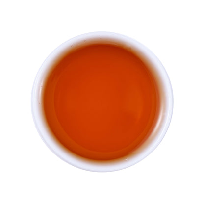 Wild black tea brewed tea soup showing clear amber-red liquor color with rich depth and natural brightness from Enshi, Hubei, China