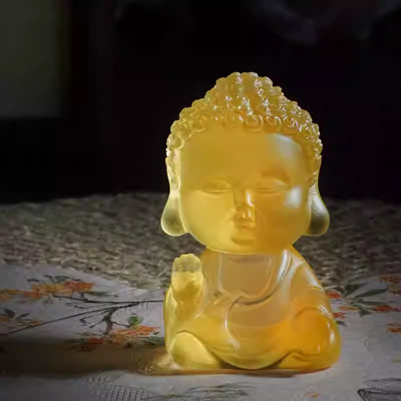 A serene, translucent yellow Little Buddha tea pet with a soft matte finish, creating a peaceful Zen atmosphere for a traditional tea ceremony.